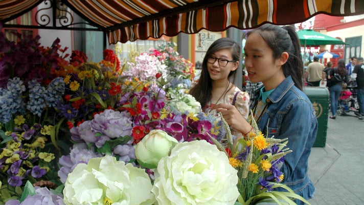 Sally Guo and Susanna Niu admire the flowers in “Paris” at Universal Studios Hollywood