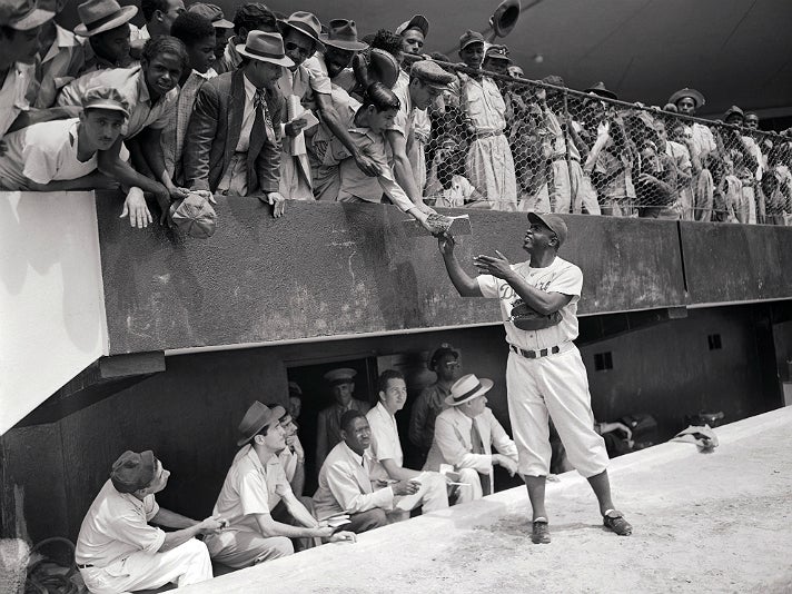 Photo of Jackie Robinson signing autographs, from "Chasing Dreams" at Skirball Cultural Center