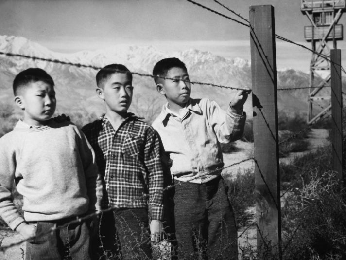 Toyo Miyatake, “Boys Behind Barbed Wire (Norito Takamoto, Albert Masaichi, and Hisashi Sansui),” 1944 [detail]. Gelatin silver print. Courtesy of Alan Miyatake, Toyo Miyatake Manzanar Collection.