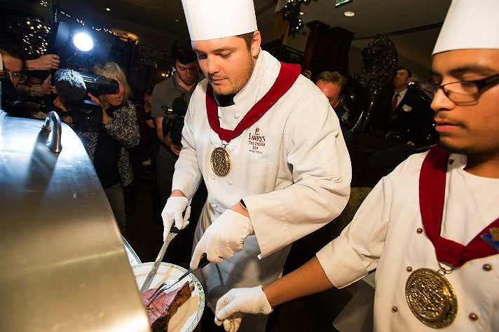 Stanford offensive lineman Brendon Austin carves the first serving of prime rib at the 60th Lawry's Beef Bowl