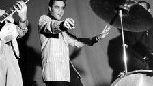 Elvis on stage in black and white