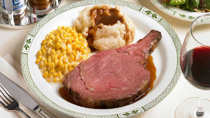 Lawry Cut prime rib dinner with creamed corn and mashed potatoes