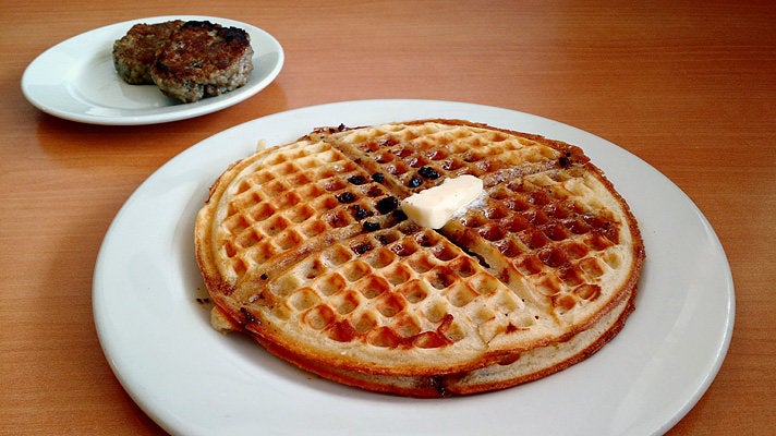 Bacon waffle with house-made sausage patties at The Nest